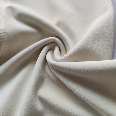 Close-up of beige fabric with a soft texture