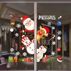 Christmas-themed window stickers on a glass door with Santa Claus, reindeer, snowmen, and presents.