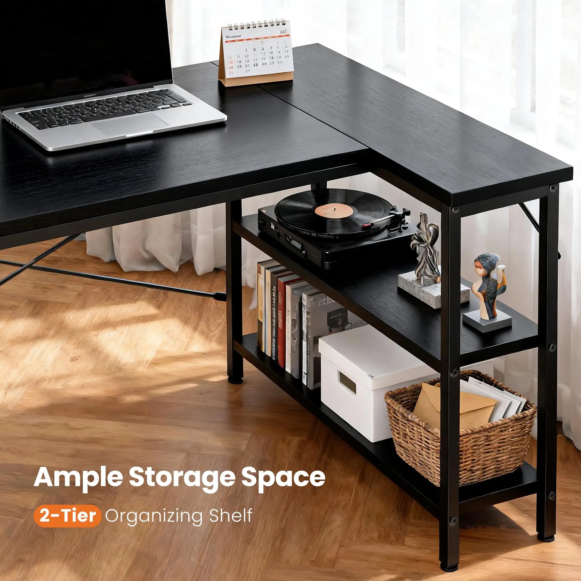 Black L-shaped desk with a 2-tier organizing shelf, laptop, calendar, and record player.