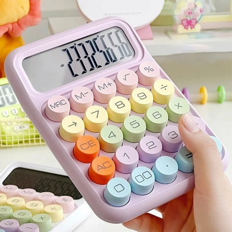 A purple keyboard calculator with colorful numbered keys and a large display screen, held in a person's hand.