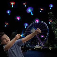 Child playing with glowing butterfly toys against a night sky with a Ferris wheel in the background