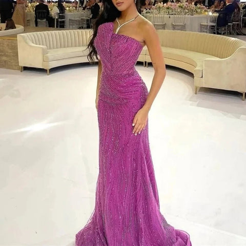 Woman in a purple beaded evening gown in an elegant indoor setting