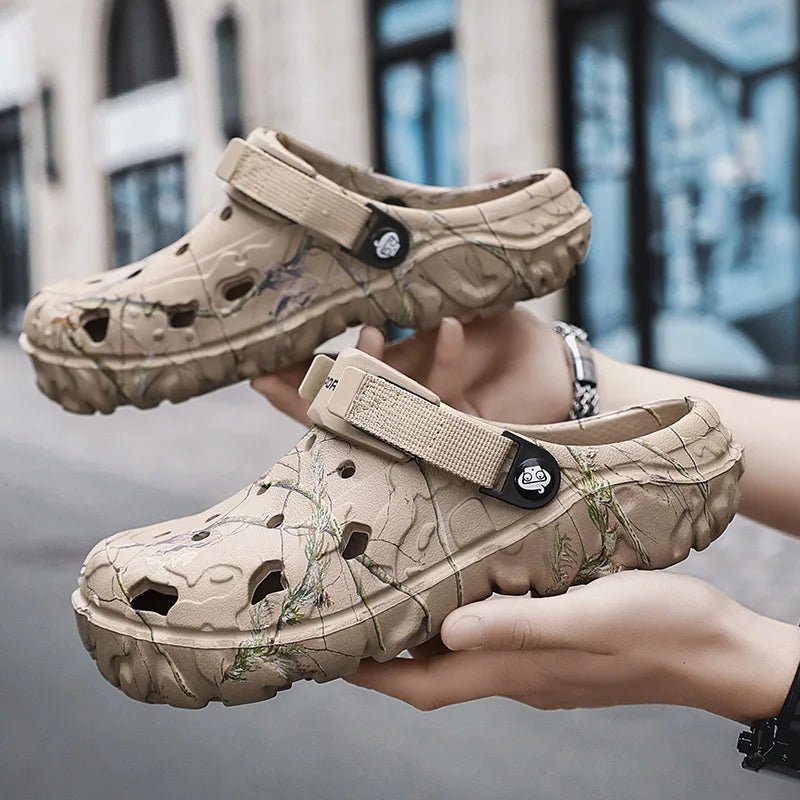 Beige clogs with floral pattern held by a person against a blurred background