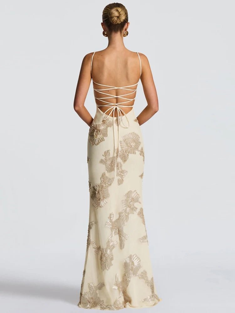 Woman wearing a floral evening gown with a lace-up back on a white background