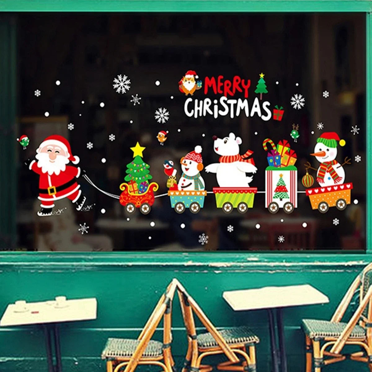 Christmas-themed window decal with Santa Claus, reindeer, and snowmen on a teal wall.