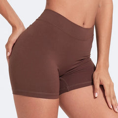 Brown athletic shorts worn by a person on a light gray background