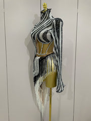 Black and white striped outfit with fringe on a mannequin against a plain background