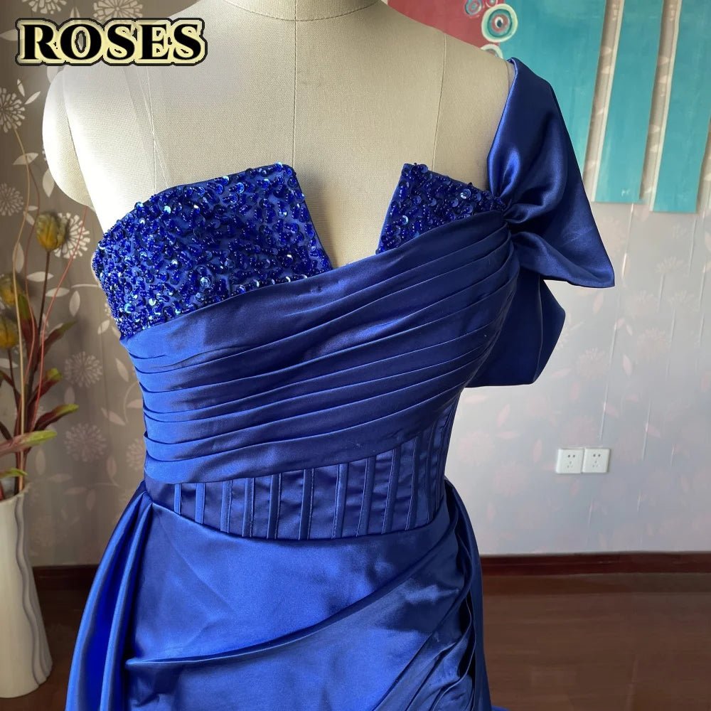 Blue evening gown with sequin details on a mannequin against a neutral background