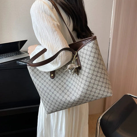 Person holding a patterned handbag in an indoor setting