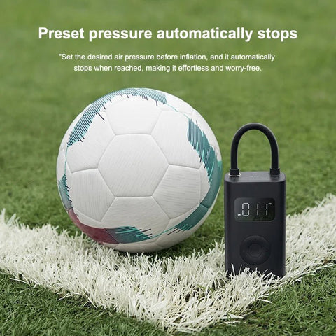 Soccer ball and digital air pump on grass with text about preset pressure
