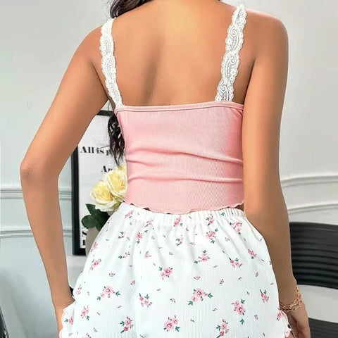 Person wearing a pink top and floral skirt with lace straps.