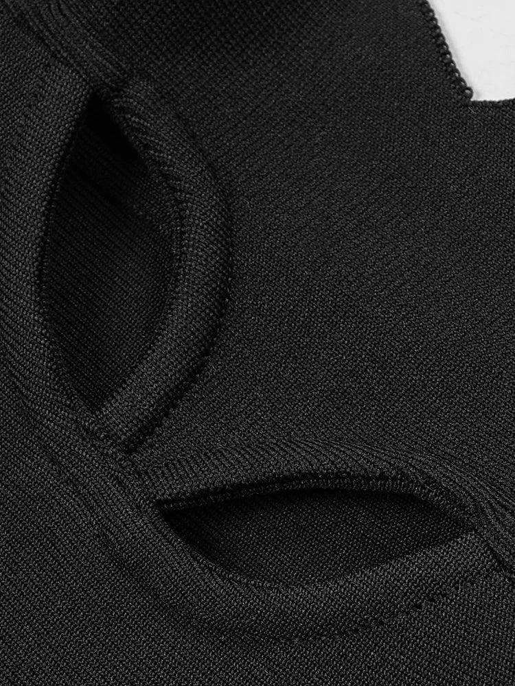 Close-up of a black cat face mask with white accents on a white background