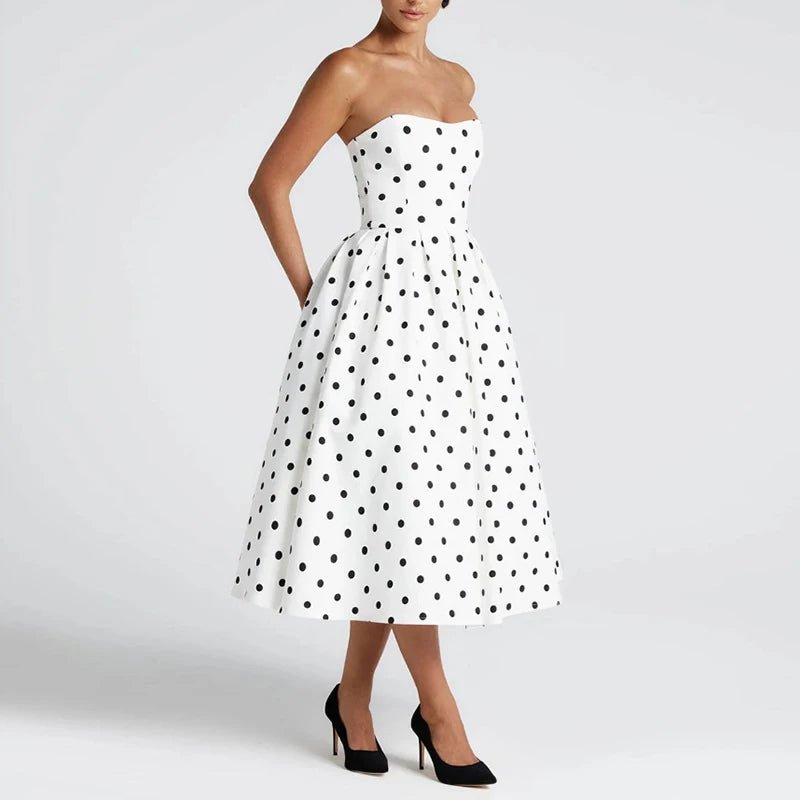 White strapless dress with black polka dots on a white background