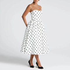 White strapless dress with black polka dots on a white background