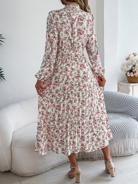 Woman wearing a floral dress in a living room setting
