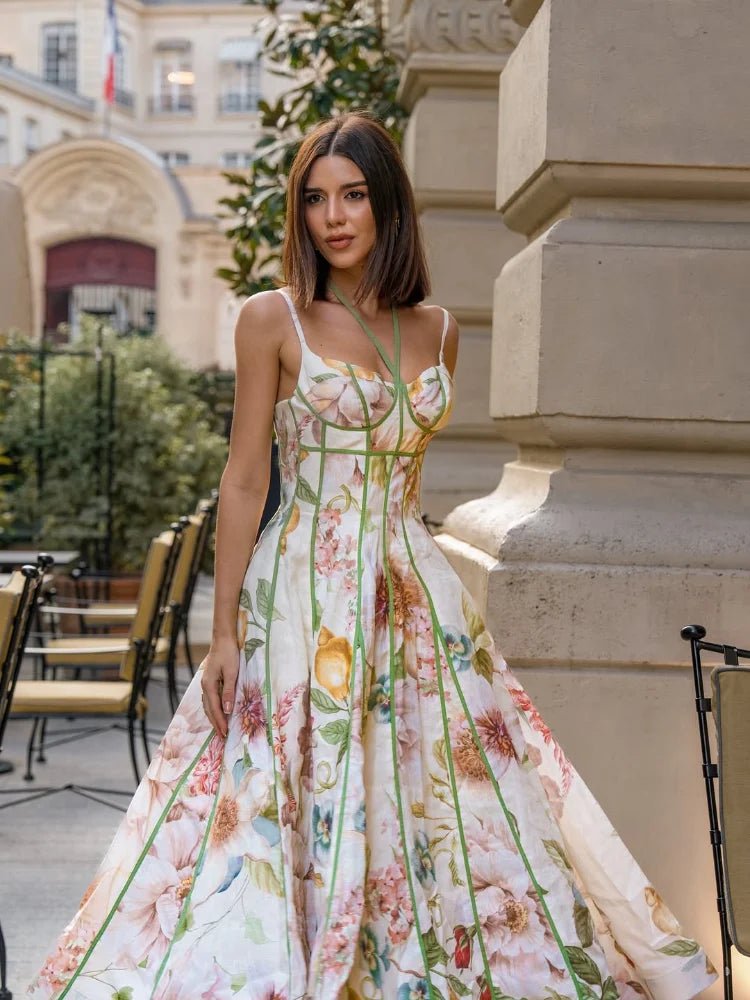 Woman in a floral dress standing outdoors near a building