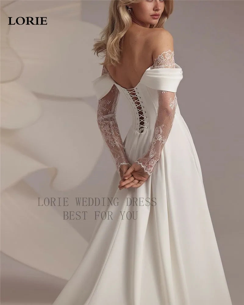 White wedding dress with lace sleeves and open back, featuring the brand 'LORIE'.