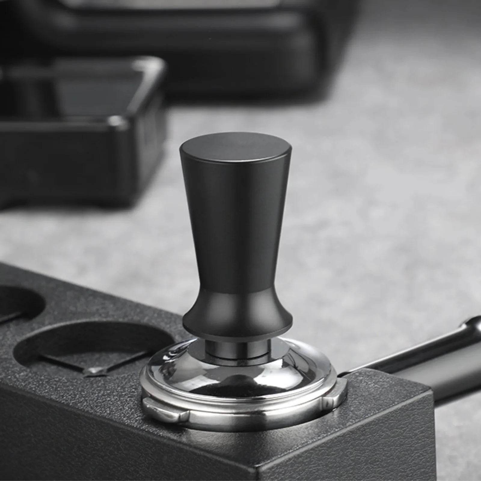 Black and silver tampers on a gray surface