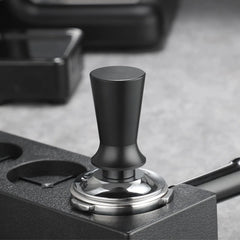 Black and silver tampers on a gray surface