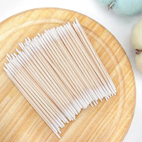 White sticks on a wooden surface with a blurred background