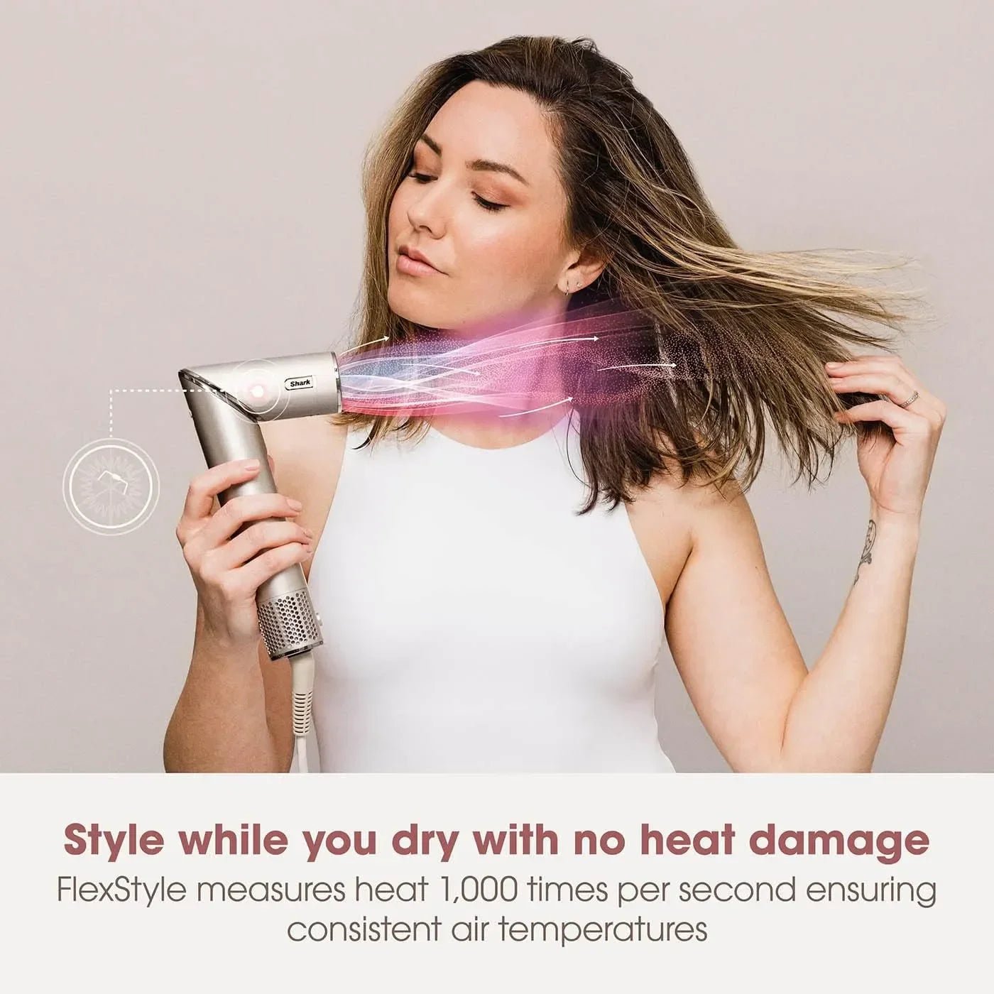 Woman using a hair dryer with a focus on styling without heat damage, set against a plain background.