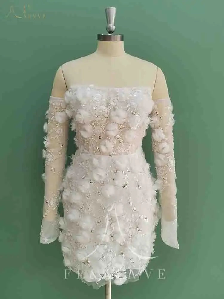 Elegant off-shoulder dress with floral and bead details on a mannequin against a green background.