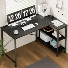 Black L-shaped desk with computer setup in a home office.