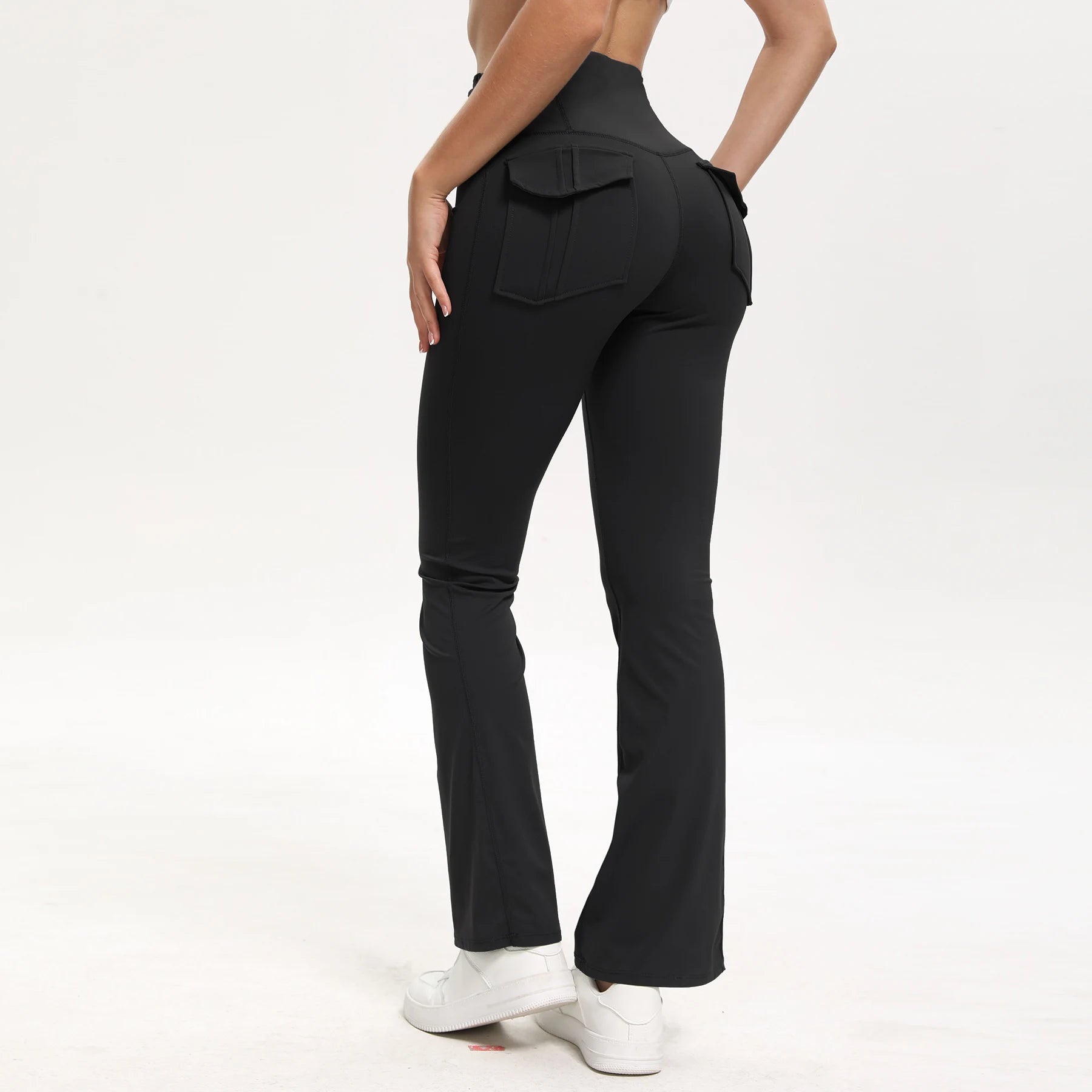 Black flared pants worn by a person on a white background