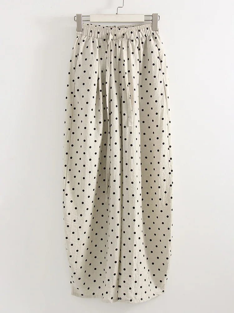 Polka dot pants hanging on a white background