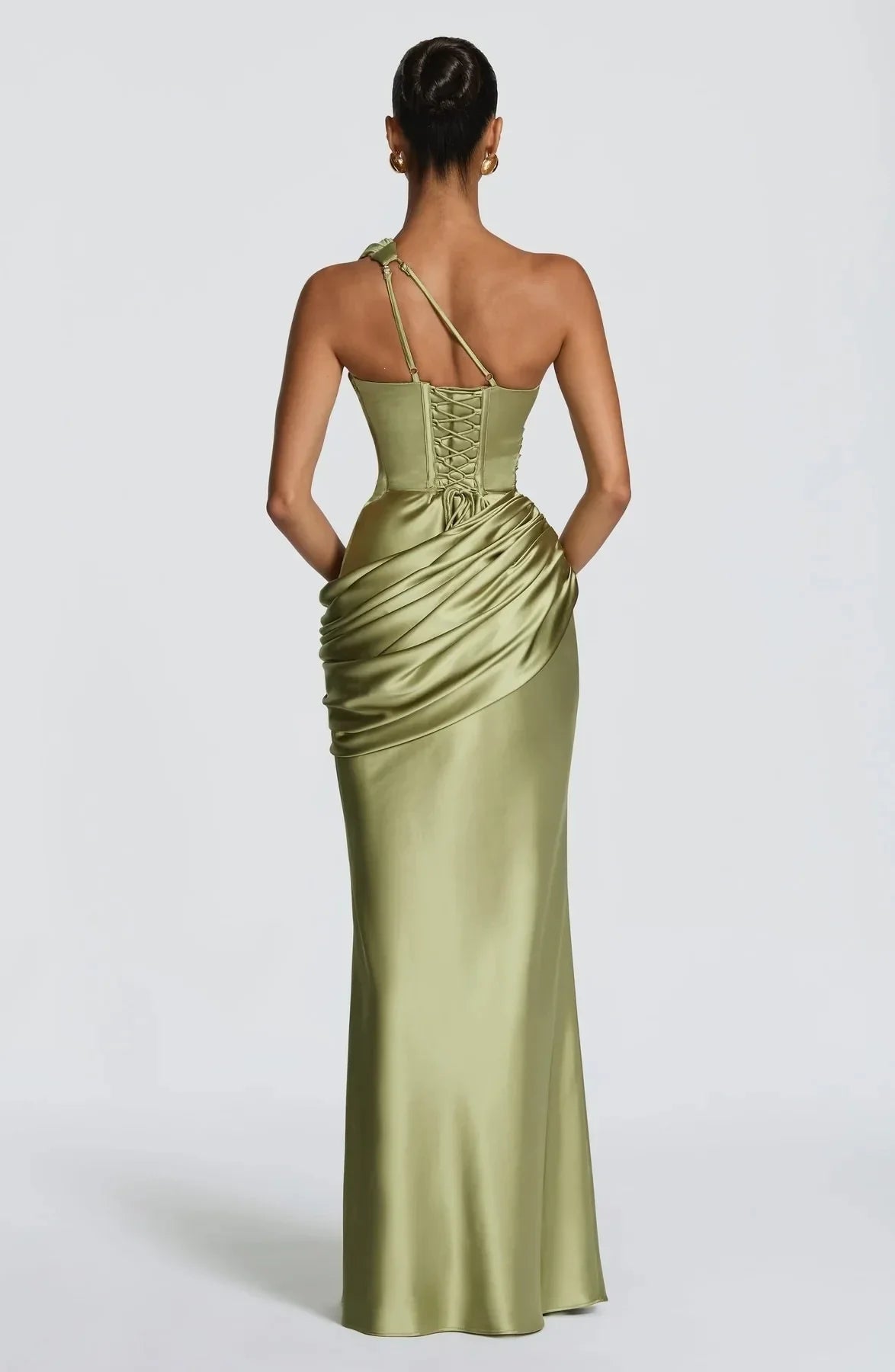 Woman wearing a green evening gown with a white background