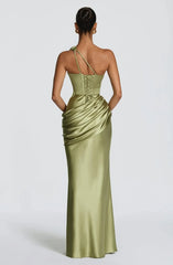 Woman wearing a green evening gown with a white background