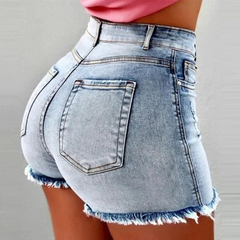 Denim shorts with frayed edges on a plain background