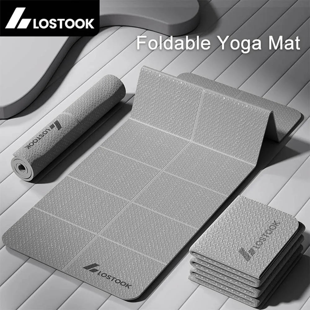 Foldable yoga mat with rolled-up mat and stacked folded mats on a wooden surface, featuring the LOSTOOK brand.