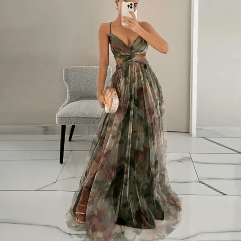 Woman wearing a floral dress in a room with a chair and mirror.