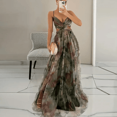 Woman wearing a floral dress in a room with a chair and mirror.