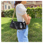 Woman with Black leather handbag purse with chunky thick chain